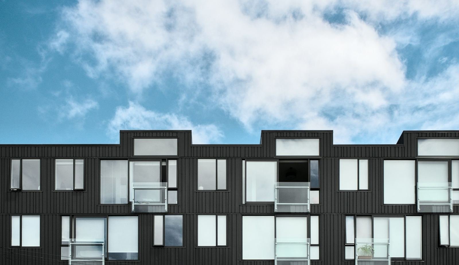 Stacked modular apartment modules with black cladding