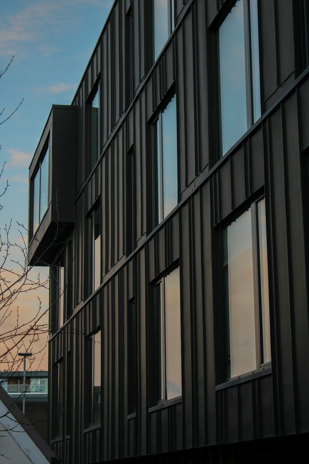 Multi-storey modular building with black vertical cladding
